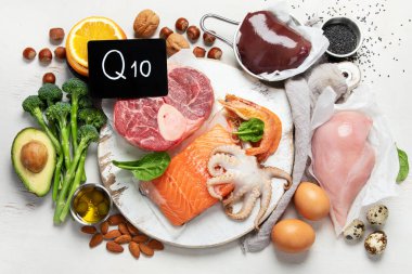 Composition with food contains coenzyme Q10, antioxidant, produce energy to cell, products against free radicals, and supports body as it ages, immune system, keeping body strong and healthy. Top view