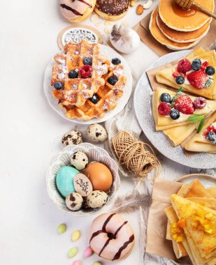 Spring Eco friendly Easter dessert table. Zero waste Easter concept Traditional natural colorful eggs. Top view, copy space