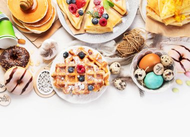 Spring Eco friendly Easter dessert table. Zero waste Easter concept Traditional natural colorful eggs. Top view, copy space