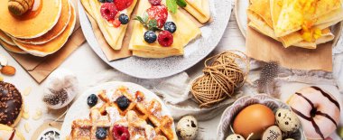 Spring Eco friendly Easter dessert table. Zero waste Easter concept Traditional natural colorful eggs. Top view, panorama, banner