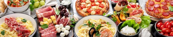 Italian food dishes on dark background. Traditional italian cuisine  concept. Dishes and appetizers of indeed cuisine. Mideterranean diet food high in vitamin and antioxidants. Panorama, banner