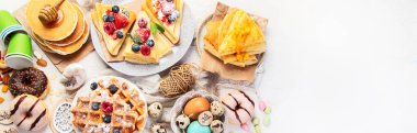 Spring Eco friendly Easter dessert table. Zero waste Easter concept Traditional natural colorful eggs. Top view, copy space, panorama, banner