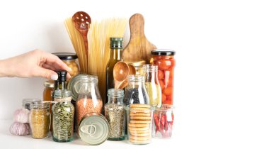 Food supplies crisis food stock. Different glass jars with grains, pasta, cans of canned food on  white background. clipart