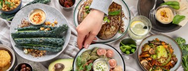 Taze ve sağlıklı vejetaryen masası, nohut, Buda kasesi, balkabağı, brokoli, kinoa, filiz ve diğerleri. Hafif arkaplan. Üst Manzara. Panorama.