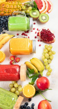 Taze meyve ve sebze suyu ya da çeşitli içerikli hafif arka plan içerikli meyve suyu. Üst görünüm