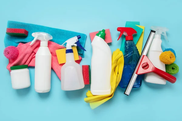 Cleaning supplies collection on blue background. Housework, cleaning service concept. Top view