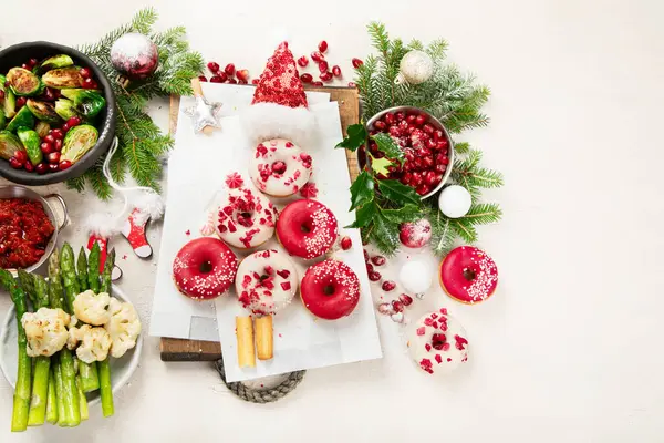 Concept of Christmas or New Year dinner with roasted meat and various vegetables dishes on a white background. Top view.