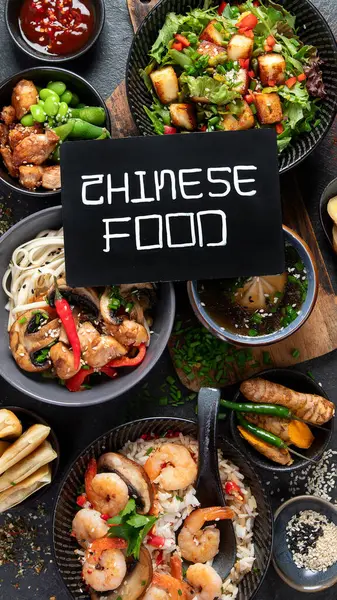 Asian food background with various ingredients on a black background, top view.