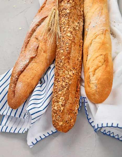 Fresh baguette bread on light background. Traditional French food.