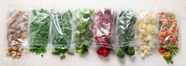 stock image Set of different frozen vegetables in plastic bags on white background. Top view. Panorama.