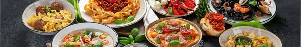Italian food dishes on dark background. Traditional food concept. Banner.