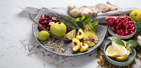 Variety of immunity boosting foods. Flat-lay of ginger, turmeric,  citrus fruit, herbs, garlic on a white background, top view. Healthy, vegan virus defeating ingredients, panorama with copy space.