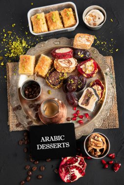 Türkçe zevklerin çeşitli parçalarının olduğu sıcak ve lezzetli bir kahve koyu bir arka planda bozulur. Geleneksel Arap yemekleri. Üst görünüm.