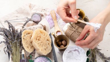 Organik kozmetik konsepti, yağlı cam şişe, pipet ve lavanta çiçekleri, arka planda fırça. Ev yapımı kozmetik ve güzellik konsepti. Üst görünüm.