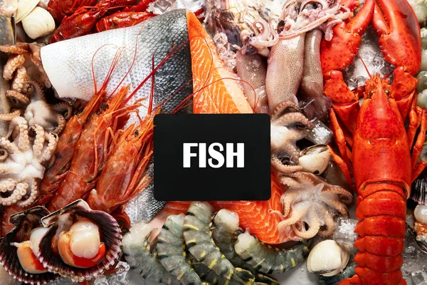 Assortment of fresh raw fish and seafood. Healthy and balanced diet or cooking concept. Top view.