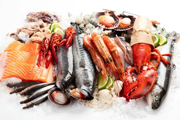 Various seafood and fishes dishes. Healthy food concept on white background, top view.
