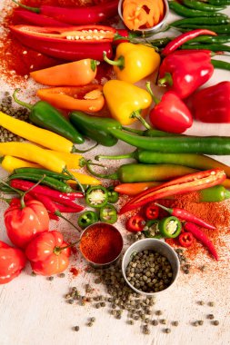 Peppers assorty on wooden background. Tasty vegetables. Colorful organic food. Top view clipart