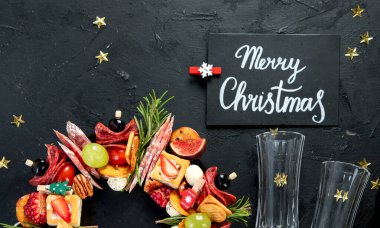 Noel yemeği geçmişi. Yılbaşı çelengi. Karanlık bir arka planda, üst tarafta..