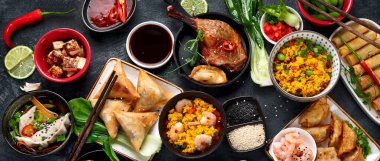 Koyu gri arka planda çeşitli Çin yemekleri ve atıştırmalıklar. Geleneksel gıda konsepti. Üst manzara, düz uzanma