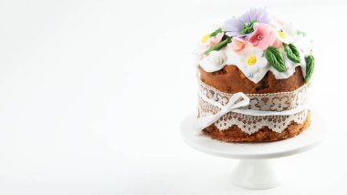 Paskalya pastası, tavşan kulaklarıyla süslenmiş tatlı ekmek ve pembe arka planda bahar çiçekleri. Üst Manzara. Boşluğu kopyala.