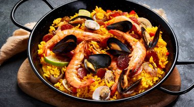 Seafood Paella on gray background. Mediterranean diet. Traditional food concept. panorama, copy space clipart