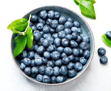 Fresh blueberry on neutral background. Vegan and vegetarian concept. Top view