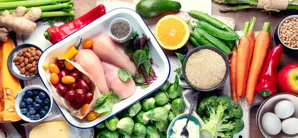 Dengeli diyet geçmişi. Taze meyve, sebze, süper yiyecek ve tavukla sağlıklı beslenme ve pişirme konsepti. Üst görünüm