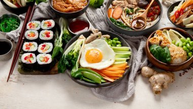 Geleneksel Kore yemekleri. Bibimbap, geleneksel Kore yemeği, pirinç, sebze, beyaz arka planda Kimchi. Üst Manzara. Boşluğu kopyala.