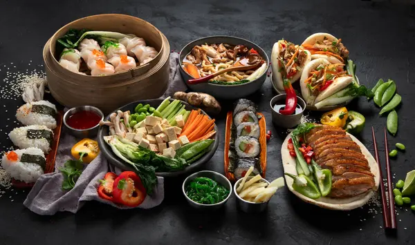 Siyah arka planda servis edilen Asya yemekleri. Asya yemekleri konsepti. Üst görünüm.