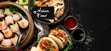 Çin mantısı, soya sosu, karanlık bir arka planda Çin mantısı. Geleneksel Asya yemekleri konsepti. Üst Manzara. Boşluğu kopyala.