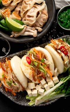 Çin mantısı, soya sosu, karanlık bir arka planda Çin mantısı. Geleneksel Asya yemekleri konsepti. Üst Manzara. Boşluğu kopyala.