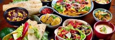 Esmer arka planda geleneksel Meksika yemeği karışımı. Panorama, bayrak