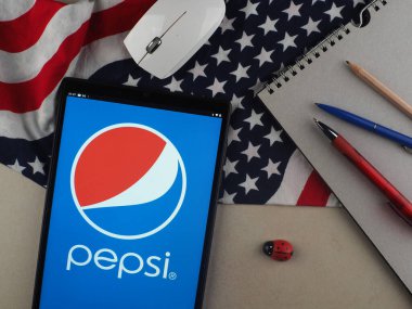 In this photo illustration, Pepsi logo seen displayed on a tablet.