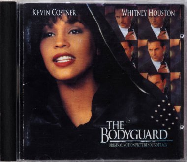 Bavaria, Germany - December 21. 2023: In this photoillustration  album The Bodyguard original motion picture soundtrack compact disk (CD). This film stars Kevin Costner and Whitney Houston. All songs performed by Whitney Houston