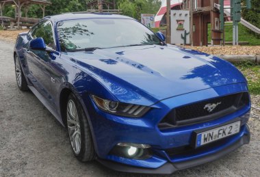 Ford Mustang GT sixth generation after restyling with a 5.0 engine. The sixth generation of the Mustang was introduced in 2013, and on September 14, 2022, the seventh generation of the iconic car was presented. - A traditional exhibition of American  clipart