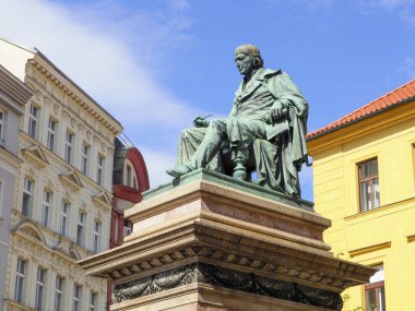 Prague, Czech Republic - May 10, 2024: The monument to Joseph Jungmann by sculptor Ludwig Schimek was unveiled in 1878. Josef Jungmann (1773 - 1847) - Czech poet and philologist, was one of the figures who contributed to the revival of the Czech lang clipart