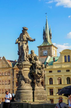 Prague, Czech Republic - May 10, 2024: Statue of St Ivo Kermartin, Charles Bridge. Saint Ivo is a saint of the Roman Catholic Church, tertiary of the monastic order of the Franciscans, patron of Brittany, the poor, widows and orphans. clipart