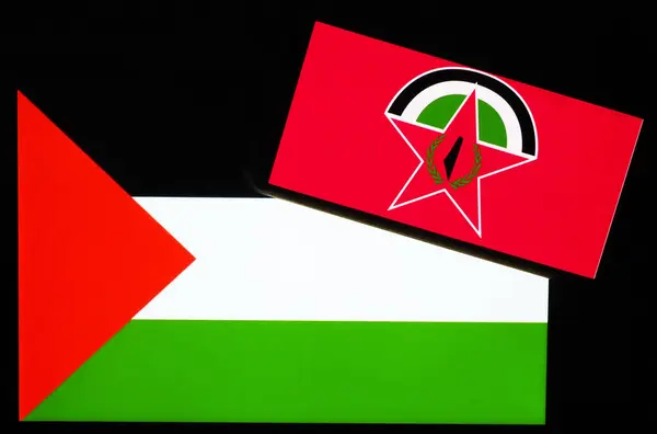 stock image Ukraine - June 19, 2024: In this photo illustration, Democratic Front for the Liberation of Palestine  logo seen displayed on a smartphone and Palestine flag on  tablet screen. 