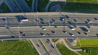 Aerial top view of lot of cars on modern road junction clipart