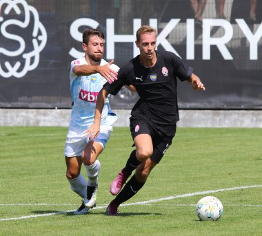 Uzhhorod, Ukrayna - 27 Ağustos 2023: Minaj 'lı Vadym Vitenchuk, Uzhhorod' daki Minaj Premier Ligi 'nde oynanan VBET Ukrayna Premier Ligi maçı sırasında Zorya Luhansk' lı Petar Micin topu için mücadele etti.