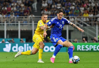 Milan, Italy - September 11, 2023: Vitaliy Mykolenko of Ukraine (L) fights for a ball with Nicolo Zaniolo of Italy during their UEFA EURO 2024 Qualifying game at Stadio San Siro. Italy won 2-1 clipart