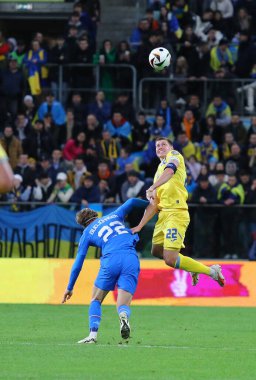 Wroclaw, Polonya - 26 Mart 2024: Ukraynalı Mykola Matviyenko (R) Wroclaw 'daki Tarczynski Arena' da oynanan UEFA EURO 2024 play-off maçı sırasında İzlandalı Andri Gudjohnsen ile top için mücadele ediyor.