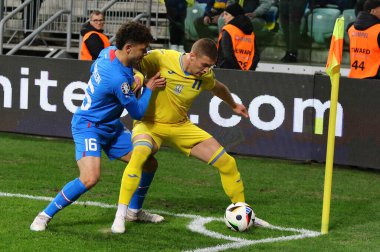 Wroclaw, Polonya - 26 Mart 2024: Ukraynalı Artem Dovbyk, Tarczynski Arena 'da oynanan UEFA 2024 play-off maçı sırasında İzlandalı Mikael Anderson ile top için mücadele etmektedir. Ukrayna 2-1 kazandı.