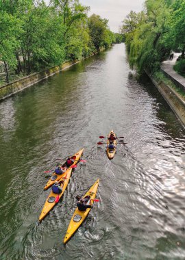 Berlin, Almanya - 14 Nisan 2024: Berlin 'in Kreuzberg ilçesindeki Landwehr Kanalı' nda (Almanca: Landwehrkanal) kayak kürekçileri yüzüyor. Landwehr Kanalı 1850 'de Spree Nehri' ne paralel olarak inşa edildi.