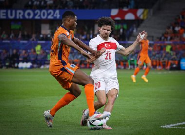 Berlin, Almanya - 6 Temmuz 2024: Hollanda 'dan Denzel Dumfries (L), Berlin' deki Olympiastadion 'da oynanan UEFA 2024 çeyrek final karşılaşmasında Türkiye' den Ferdi Kadioğlu ile top için mücadele ediyor.