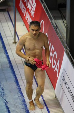 Berlin, Germany - March 24, 2024: Diver Shixin LI of Australia reacts after his jump during the Men's 3m Springboard Final of the World Aquatics Diving World Cup 2024 in Berlin, Germany clipart