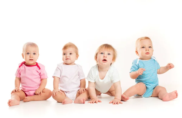 Grupo Bebés Ingeniosos Sentados Diferentes Ropas Aislados Sobre Fondo Blanco —  Fotos de Stock