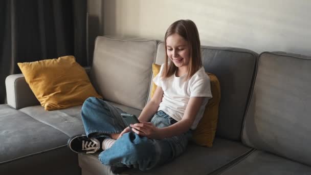 Preteen Girl Smartphone Chattet Mit Freunden Auf Dem Sofa Hause — Stockvideo