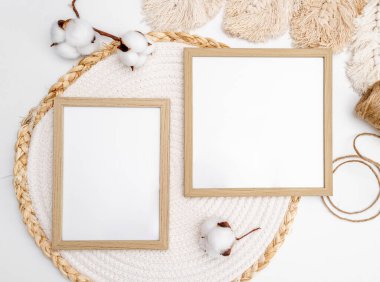 Wooden frame for photos, twine thread and linen flowers mockup. Minimal template with empty picture blank beige and boho style decoration scandinavian composition