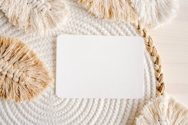 Watercolor paper postcard blank in boho decor with knitted feathers simple composition. Aquarelle empty card in minimal natural design arrangment with copy space